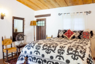<p>Here’s one of the cozier bedrooms. Three of them have a private door out to the heated pool (Airbnb) </p>