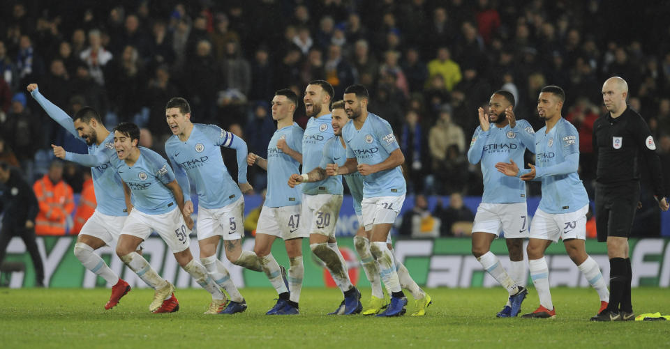 Mancester City players react as Manchester City's Oleksandr Zinchenko scores the dicing penalty during the English League Cup quarterfinal soccer match at the King Power stadium in Leicester, England, Tuesday, Dec.18, 2018. Manchester City won 3-1 in a penalty shoot out after the match ended in a 1-1 draw in normal time. (AP Photo/Rui Vieira)