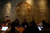 People sit at a Starbucks flagship store in Beijing