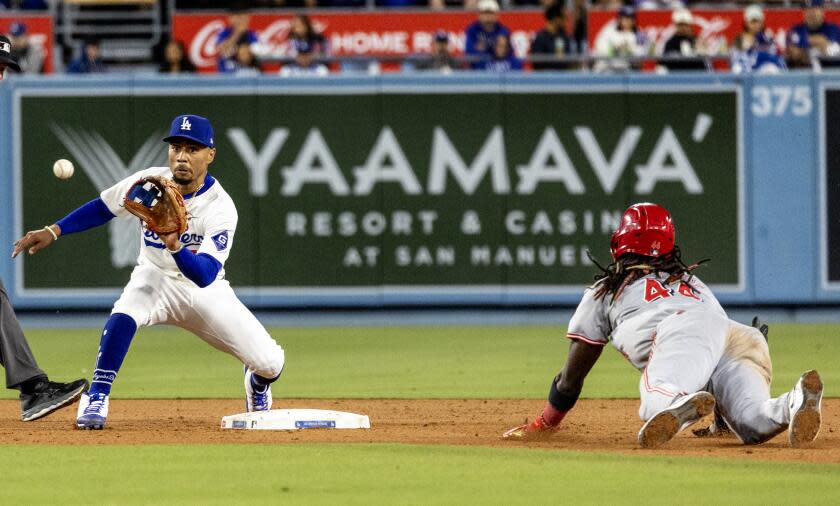 LOS ANGELES, CA - MAY16, 2024: Los Angeles Dodgers shortstop Mookie Betts (50) takes the throw from Los Angeles Dodgers catcher Austin Barnes (15) to tag out Cincinnati Reds shortstop Elly De La Cruz (44) attempting to steal in the seventh inning at Dodger Stadium on May 16, 2024 in Los Angeles, California.(Gina Ferazzi / Los Angeles Times)