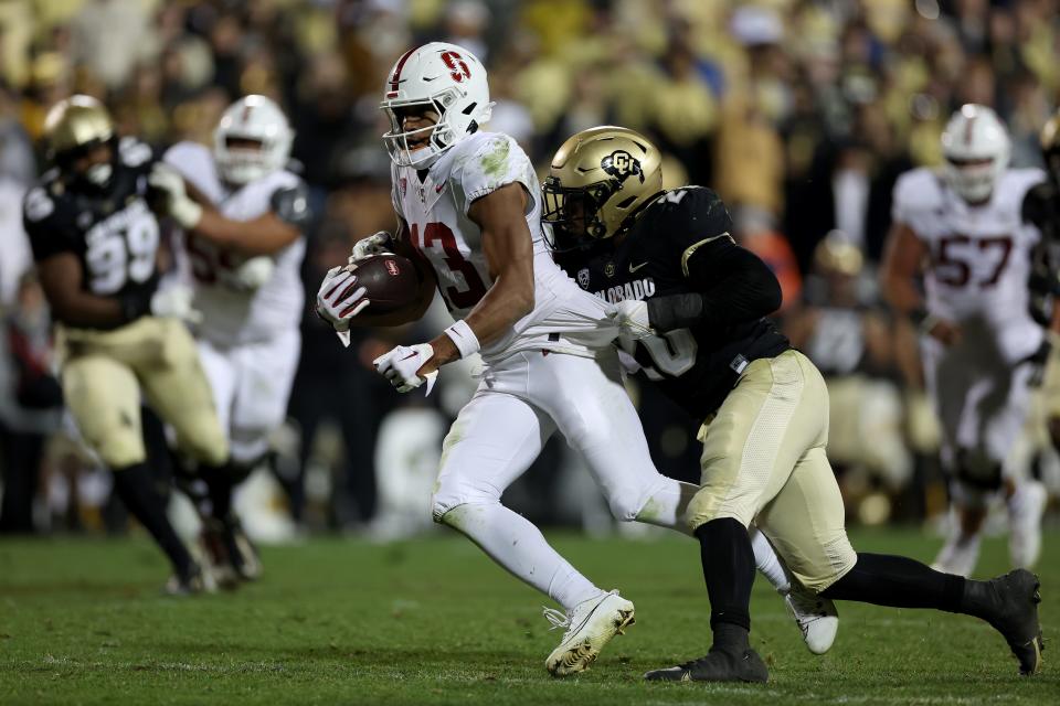 BOULDER, COLORADO - OCTOBER 13: Elic Ayomanor #13 of the Stanford Cardinal carries the ball after making a catch against LaVonta Bentley #20 of the Colorado Buffaloes in the fourth quarter at Folsom Field on October 13, 2023 in Boulder, Colorado . (Photo by Matthew Stockman/Getty Images)