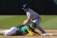 Oakland Athletics' Brett Harris, left, slides back safely to second base next to Texas Rangers shortstop Josh Smith on a pickoff attempt during the sixth inning in the second baseball game of a doubleheader Wednesday, May 8, 2024, in Oakland, Calif. (AP Photo/Godofredo A. Vásquez)