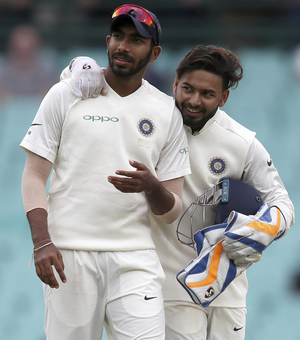India's Rishabh Pant, right, and Jasprit Bumrah smile after Australia's first innings come to an end on day 4 of their cricket test match in Sydney, Sunday, Jan. 6, 2019. (AP Photo/Rick Rycroft)