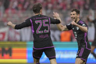 Bayern's Thomas Mueller celebrates with his teammate Leon Goretzka after scoring his side's third goal during the German Bundesliga soccer match between FC Union Berlin and Bayern Munich at the An der Alten Forsterei stadium in Berlin, Germany, Saturday, April 20, 2024. (AP Photo/Ebrahim Noroozi)