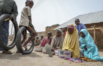 Children play and sell small foodstuffs on the street in the town of Jangebe, from where more than 300 girls were abducted by gunmen on Friday at the Government Girls Junior Secondary School, in Zamfara state, northern Nigeria Saturday, Feb. 27, 2021. Nigerian police and the military have begun joint operations to rescue the more than 300 girls who were kidnapped from the boarding school, according to a police spokesman. (AP Photo/Ibrahim Mansur)