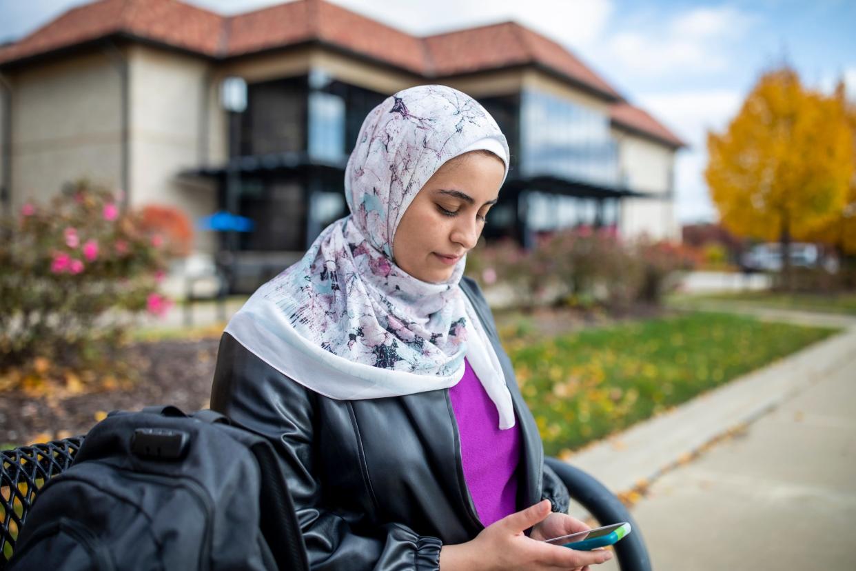 Sara Shannan, 27, a student at University of Detroit Mercy where she is studying computer science, looks at photos and videos of her family’s house in Gaza City that was bombed last month, Friday, Oct. 27, 2023.