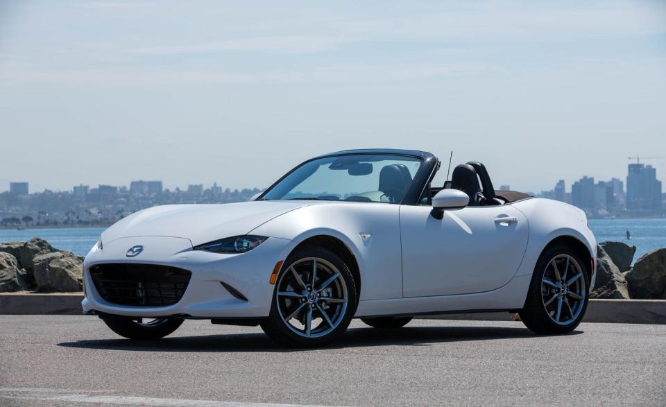 <p>Few cars deliver <a href="https://www.caranddriver.com/reviews/a15080595/2016-mazda-mx-5-miata-long-term-test-review/" rel="nofollow noopener" target="_blank" data-ylk="slk:driving thrills at an affordable price;elm:context_link;itc:0;sec:content-canvas" class="link ">driving thrills at an affordable price</a> quite like the 2022 Mazda MX-5 Miata, and it's the only affordable sports car with a convertible top. It's also on <a href="https://www.caranddriver.com/features/a38873223/2022-editors-choice/" rel="nofollow noopener" target="_blank" data-ylk="slk:our 2022 Editors' Choice list;elm:context_link;itc:0;sec:content-canvas" class="link ">our 2022 Editors' Choice list</a>. A spunky four-cylinder primarily pairs with a satisfying six-speed manual, but an automatic transmission is offered, too. The Miata's handling is eager and playful, which makes encountering twisty roads a joyful experience. Most versions come with a manually-folding soft-top, but there's a <a href="https://www.caranddriver.com/reviews/a15097184/2017-mazda-mx-5-miata-rf-first-drive-review/" rel="nofollow noopener" target="_blank" data-ylk="slk:more expensive RF model available;elm:context_link;itc:0;sec:content-canvas" class="link ">more expensive RF model available</a> with a power-folding Targa hardtop. With either roof, the Miata's interior is snug but nicely equipped, with infotainment features such as Apple CarPlay and Android Auto standard across all trims.<br></p><p><a class="link " href="https://www.caranddriver.com/mazda/mx-5-miata" rel="nofollow noopener" target="_blank" data-ylk="slk:Review, Pricing, and Specs;elm:context_link;itc:0;sec:content-canvas">Review, Pricing, and Specs</a></p>