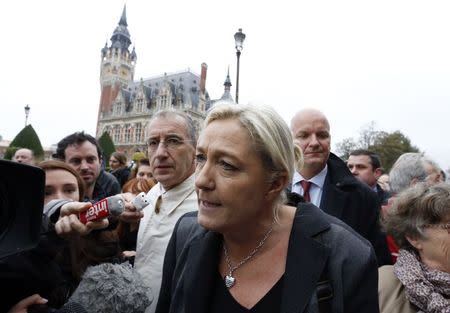 Marine Le Pen, France's National Front political party leader, speaks to journalists as she walks near the town hall in Calais October 24, 2014. REUTERS/Pascal Rossignol