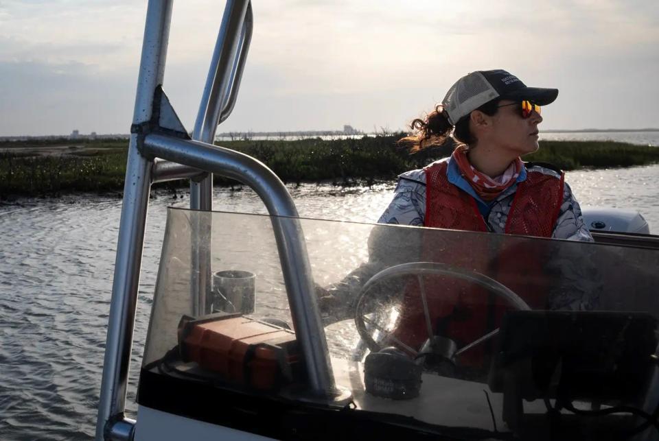 Victoria Congdon, a marine scientist with Mission-Aransas National Estuarine Research Reserve, navigates a boat through the entrance to the Lighthouse Lakes area off Port Aransas.