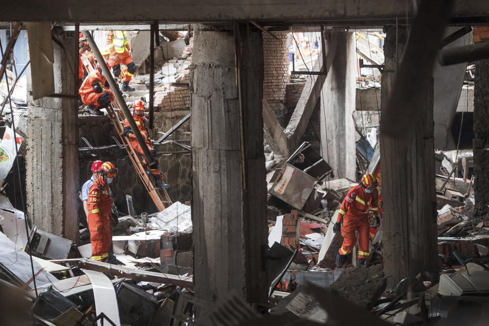 In this photo released by Xinhua News Agency, rescue workers search for survivors in the aftermath of a gas explosion in Shiyan city in central China's Hubei Province on Sunday, June 13, 2021. At least a dozen people were killed and more seriously injured Sunday after a gas line explosion tore through the residential neighborhood in central China. (Xiao Yijiu/Xinhua via AP)