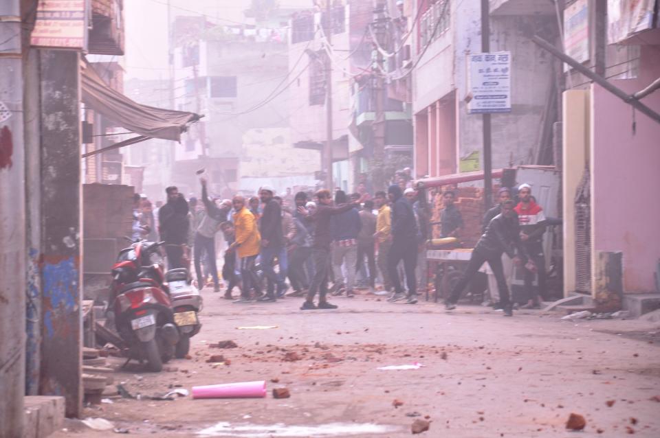 GHAZIABAD, INDIA - DECEMBER 20: Protesters pelt stones on police after Friday prayers amid anti CAA protests on December 12, 2019 in Ghaziabad, India. The act seeks to grant Indian citizenship to refugees from Hindu, Christian, Sikh, Buddhist and Parsi communities fleeing religious persecution from Pakistan, Afghanistan, and Bangladesh, and who entered India on or before December 31, 2014. The Parliament had passed the Citizenship (Amendment) Bill, 2019 last week and it became an act after receiving assent from President Ram Nath Kovind. Since then, protests including some violent ones have erupted in various regions of the country, including the North East over the amended citizenship law. (Photo by Sakib Ali/Hindustan Times via Getty Images)