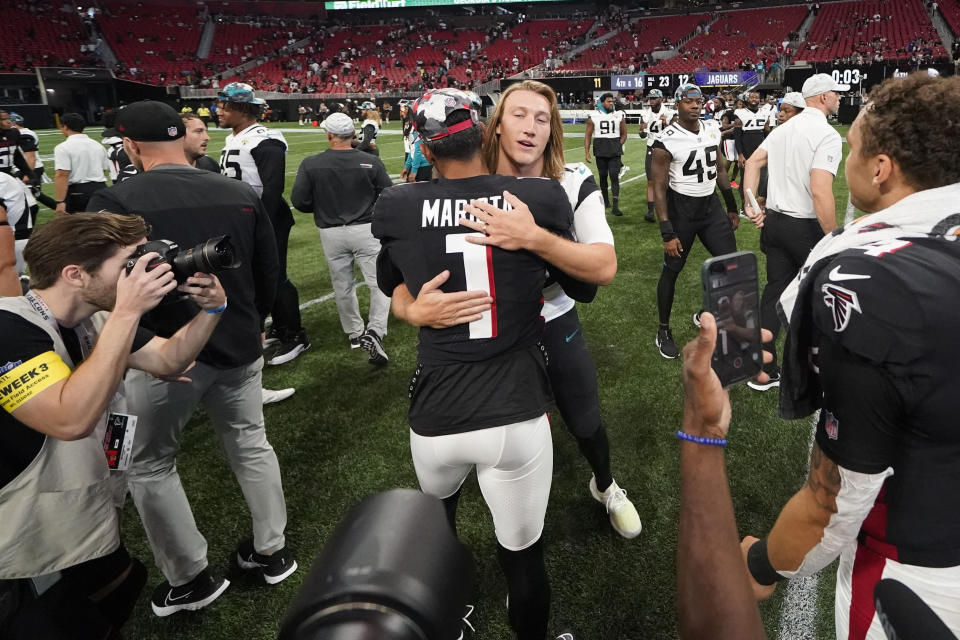 Atlanta Falcons quarterback Marcus Mariota (1) speaks with Jacksonville Jaguars quarterback Trevor Lawrence (16) after the second half of an NFL football game, Saturday, Aug. 27, 2022, in Atlanta. The Atlanta Falcons won 28-12. (AP Photo/Gerald Herbert)