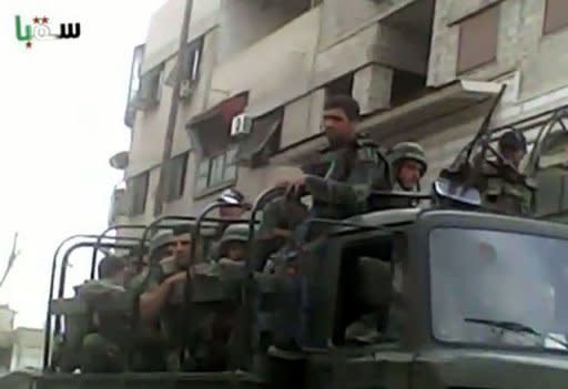 An image grab taken from a video uploaded on YouTube shows Syrian forces deploying in Saqba on the outskirts of Damascus. AFP cannot independently verify this image. Syria on Sunday demanded guarantees that armed groups cease fire before withdrawing its troops from protest hubs as agreed with special envoy Kofi Annan, even as a UN truce deadline loomed