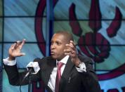 FILE - In this June 4, 2013, file photo, Toronto Raptors new general manager Masai Ujiri gestures during an NBA basketball news conference in Toronto. Raptors general manager Ujiri let loose a profanity during a pregame address meant to pump up a group of Raptors fans outside Air Canada Centre before a Saturday, April 19, 2014, opening game of the NBA playoffs. (AP Photo/The Canadian Press, Nathan Denette, File)