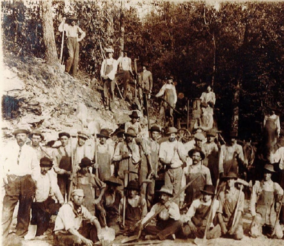 The pipeline construction crew that installed over 16 miles of 16-inch cast iron water pipe from the headwaters of the Mills River to Hendersonville pose in this 1923 photo. Much of the installation was done by hand through difficult terrain.
