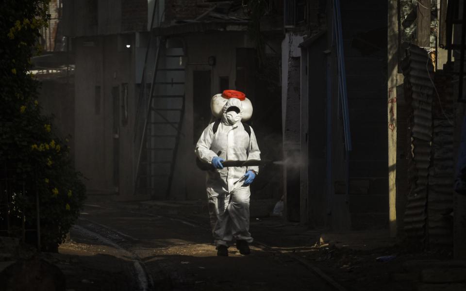 A worker disinfects the houses in Buenos Aires, Argentina - Getty