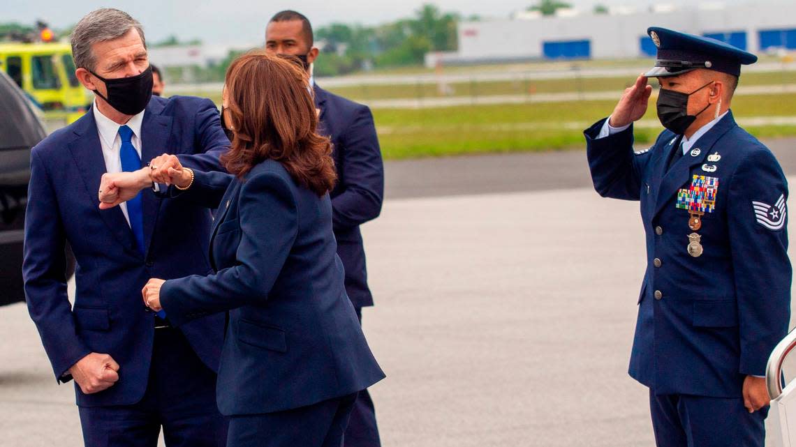 Vice President Kamala Harris elbow bumps Gov. Roy Cooper as she steps off Air Force 2 Monday, April 18, 2021 at Piedmont Triad International Airport in Greensboro.