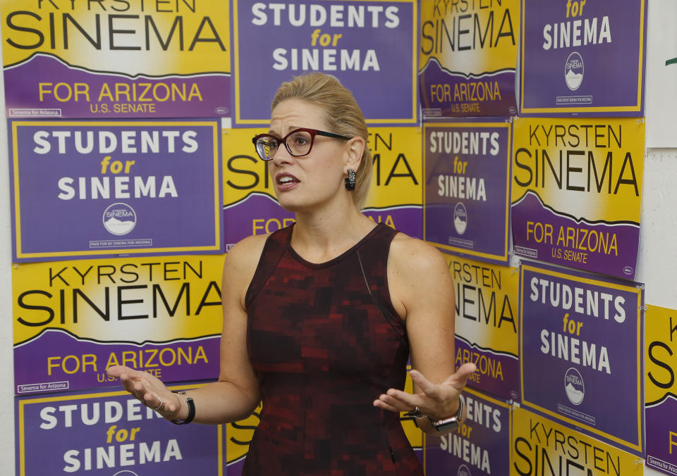 Democratic Rep. Kyrsten Sinema, who is running against Republican Rep. Martha McSally for the open Arizona Senate seat Jeff Flake, R-Ariz., is vacating, talks to campaign volunteers, Tuesday, Oct. 2, 2018, in Tempe, Ariz. Arizona's Senate race pits Sinema, a careful politician running as a centrist in a Republican-leaning state, against McSally, a onetime Trump critic turned fan. (AP Photo/Ross D. Franklin)