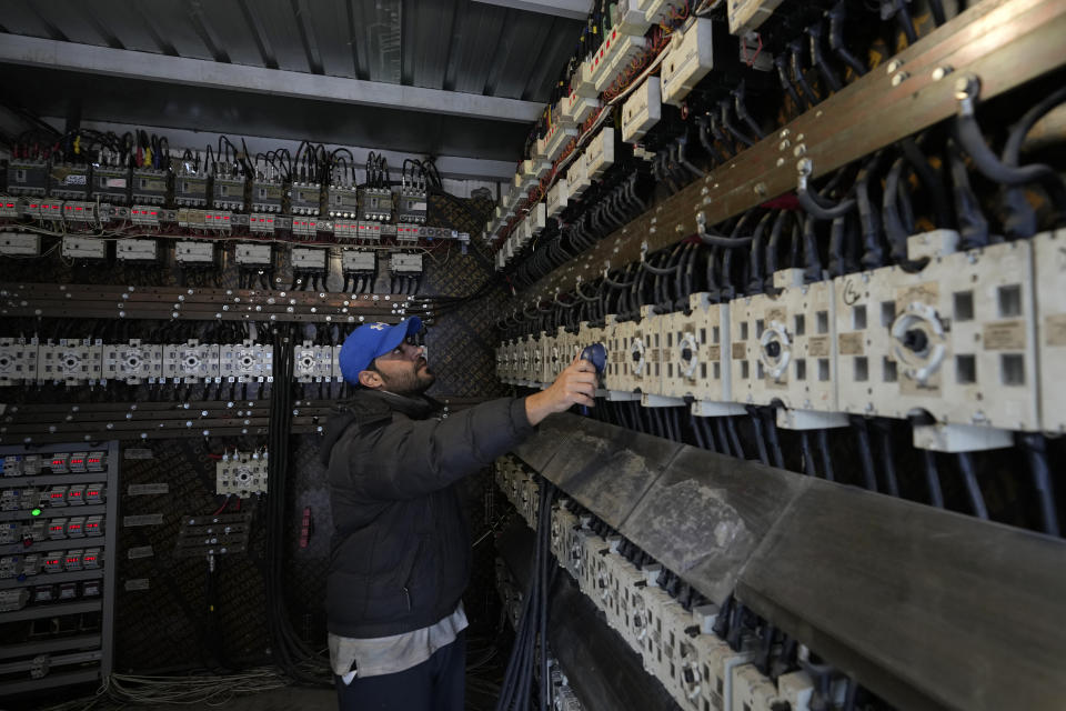 A worker switching on privately-owned diesel generators that provide power to homes and businesses in Beirut, Lebanon, March 4, 2022. Private generators are ubiquitous in parts of the Middle East, spewing hazardous fumes into homes and business across the country, almost 24 hours a day. As the world looks for renewable energy to tackle climate change, Lebanon, Iraq, Gaza and elsewhere rely on diesel-powered private generators just to keep the lights on. The reason is state failure: In multiple countries, governments can’t maintain a functioning central power network, whether because of war, conflict or mismanagement and corruption. (AP Photo/Hassan Ammar)