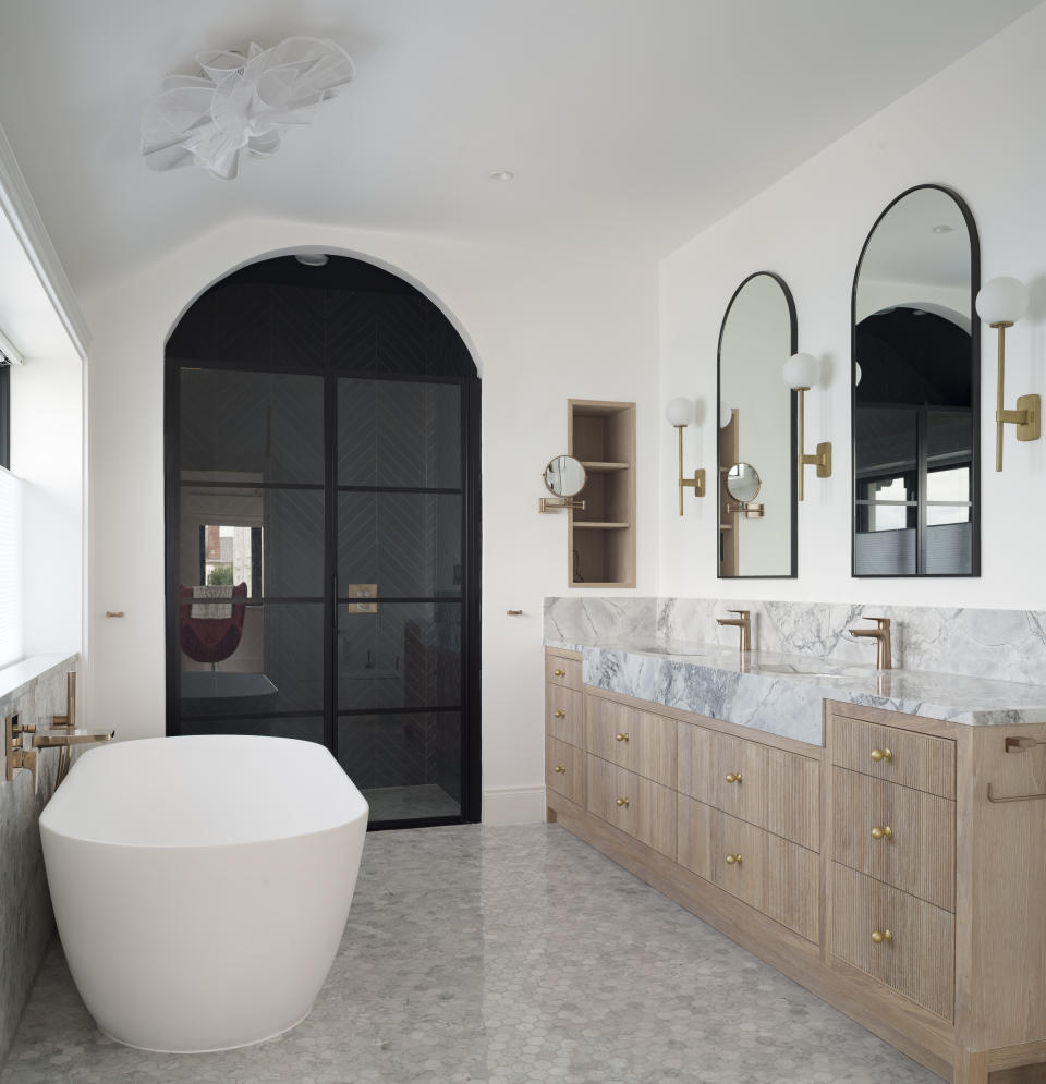 a modern bathroom with a dark shower enclosure