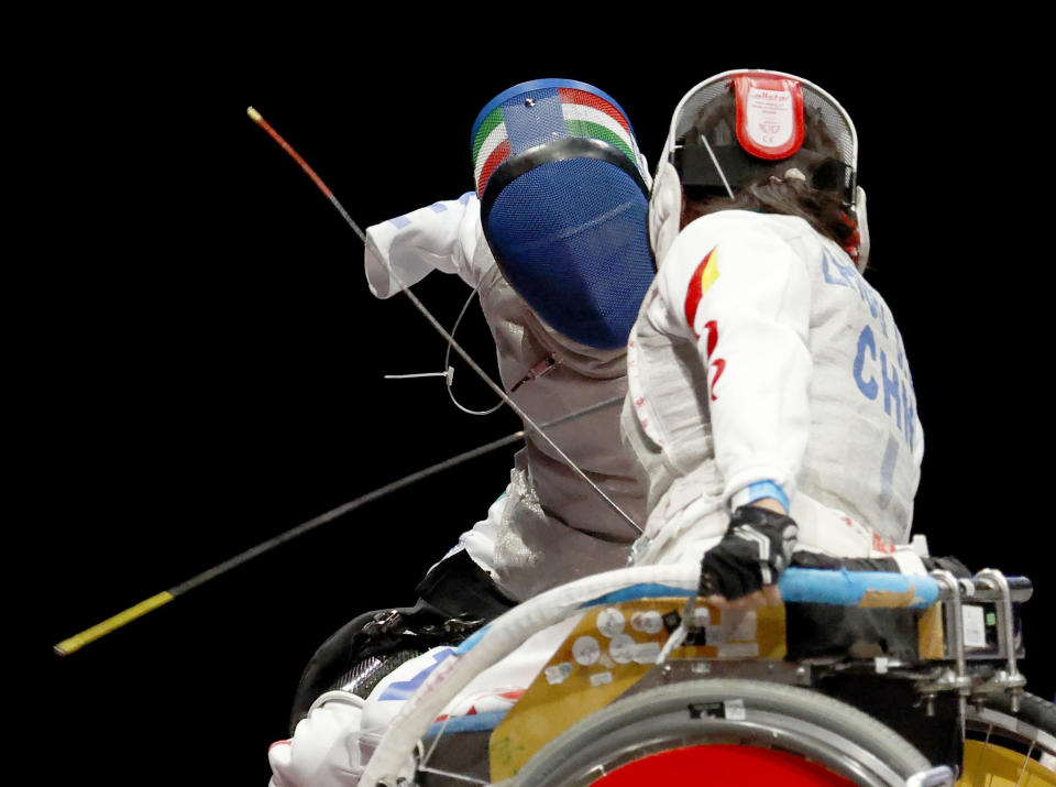 Italy's Beatrice Maria Vio, left, competes against China's Zhou Jingjing during their the wheelchair fencing women's foil Individual category B gold medal match in Chiba, near Tokyo, at the Tokyo 2020 Paralympic Games, Saturday, Aug. 28, 2021, in Tokyo, Japan. (Kyodo News via AP)