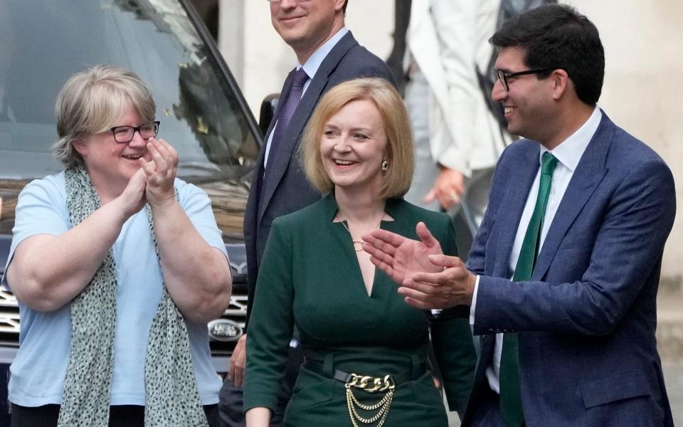 Liz Truss is applauded by her campaign team in Westminster after picking up enough votes to make the final two of the Tory leadership contest - Frank Augstein/AP