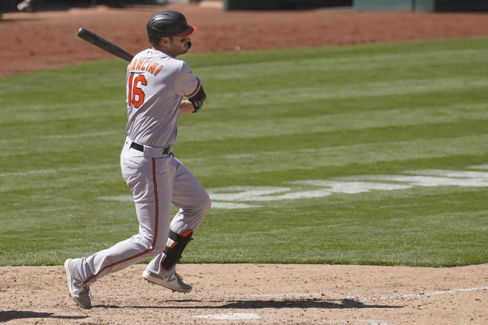 Baltimore Orioles' Trey Mancini hits an RBI-single against the Oakland Athletics during the seventh inning of a baseball game in Oakland, Calif., Sunday, May 2, 2021. (AP Photo/Jeff Chiu)