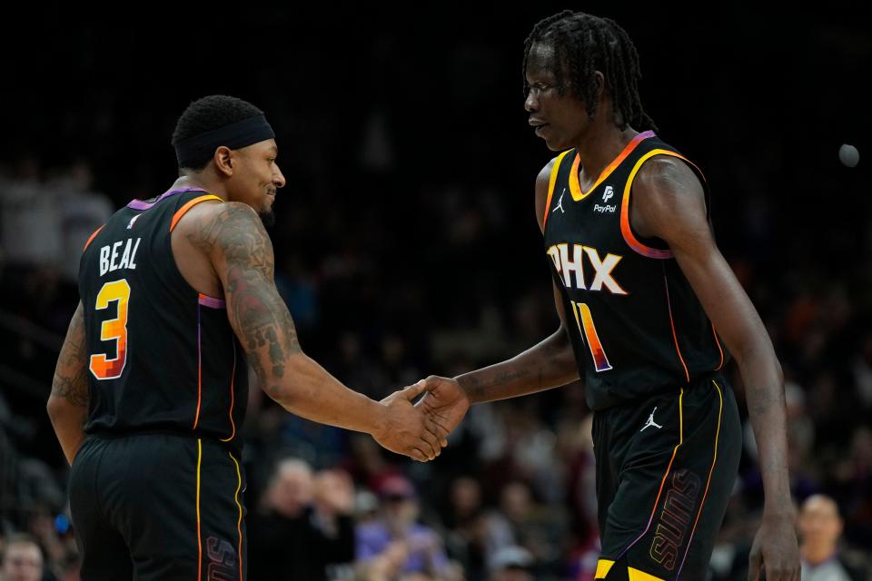 Phoenix Suns guard Bradley Beal (3) and center Bol Bol (11) reacts after scoring against the Portland Trail Blazers in the first half at Footprint Center.