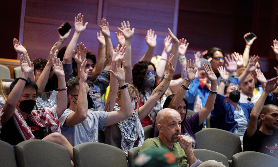 Protesters at a City Council meeting on Sept. 9, 2024, object to what they say is the politicizing and exaggeration of an alleged Venezuelan gang problem in the city. (Tri Duong / Sentinel Colorado via AP)