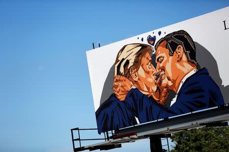 A billboard erected in advance of the Republican National Convention depicts U.S. Republican presidential candidate Donald Trump kissing former presidential candidate Sen. Ted Cruz (R-TX) in Cleveland, Ohio July 15, 2016. REUTERS/Aaron P. Bernstein