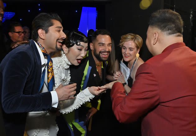 Santos (right) proudly shows off his engagement ring to actors Mark Indelicato, Poppy Liu and Johnny Sibilly. (Photo: Stefanie Keenan via Getty Images)