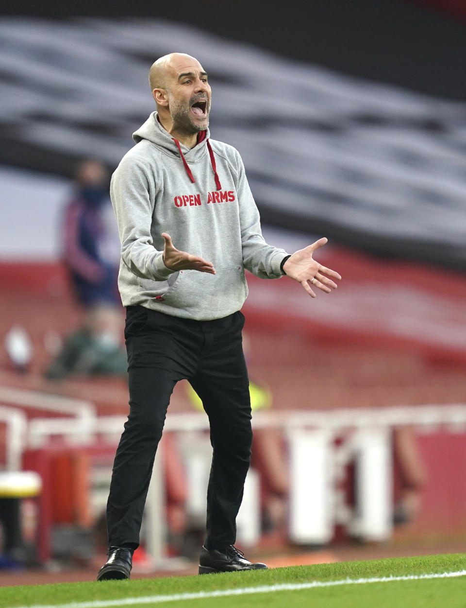 Manchester City's head coach Pep Guardiola reacts during the English Premier League soccer match between Arsenal and Manchester City at the Emirates stadium in London, England, Sunday, Feb. 21, 2021. (John Walton/Pool via AP)