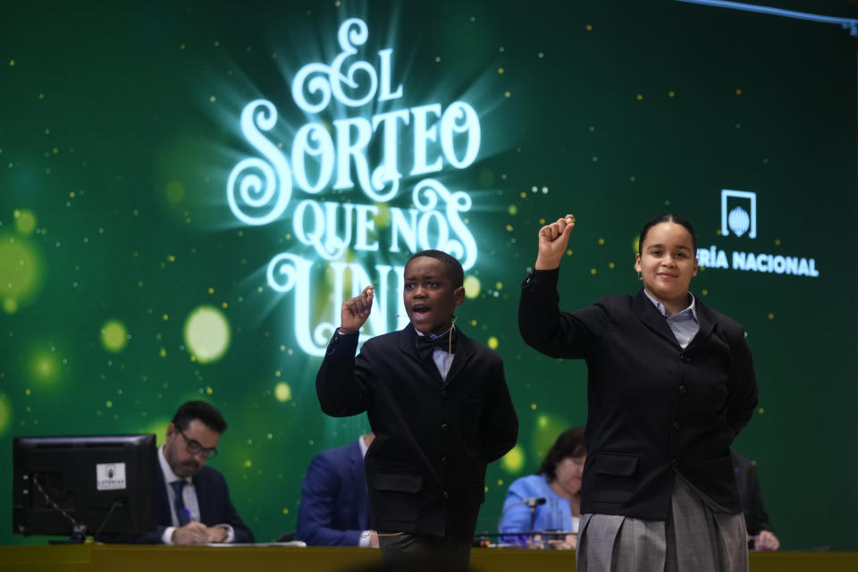 Children from Madrid's San Ildefonso school sing out the numbers from one of the main prizes from awarded lottery balls at Madrid's Teatro Real opera house during Spain's bumper Christmas lottery draw known as El Gordo, or The Fat One, in Madrid, Spain, Friday, Dec. 22, 2023. The lottery will shell out 400,000 euros ($440,000) to holders of 20-euro tickets bearing the top-prize number. The immensely popular lottery will distribute a total of 2.6 billion euros in prizes this year, much of it in small prizes. Street and bar celebrations normally break out with winners uncorking bottles of sparkling wine and singing and dancing. (AP Photo/Paul White)