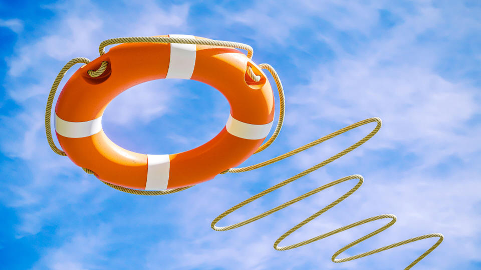 Orange lifebuoy on sky background.