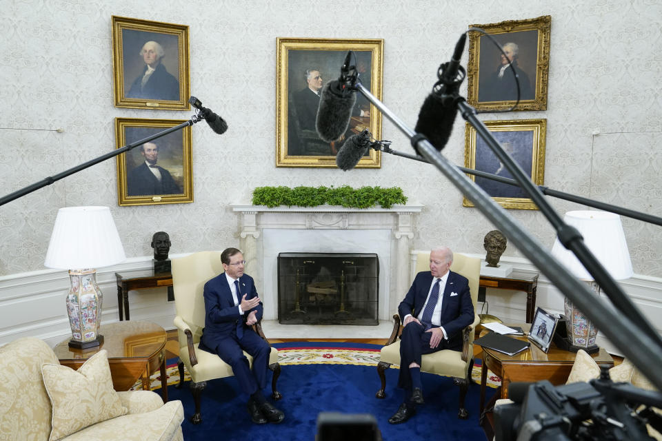 Israel's President Isaac Herzog, left, speaks during a meeting with President Joe Biden in the Oval Office of the White House, Wednesday, Oct. 26, 2022, in Washington. (AP Photo/Patrick Semansky)