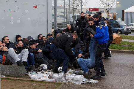 Prison wardens are grouped together by French gendarmes as they block the Lyon-Corbas jail near Lyon during a nationwide protest, in France, January 22, 2018. REUTERS/Emmanuel Foudrot