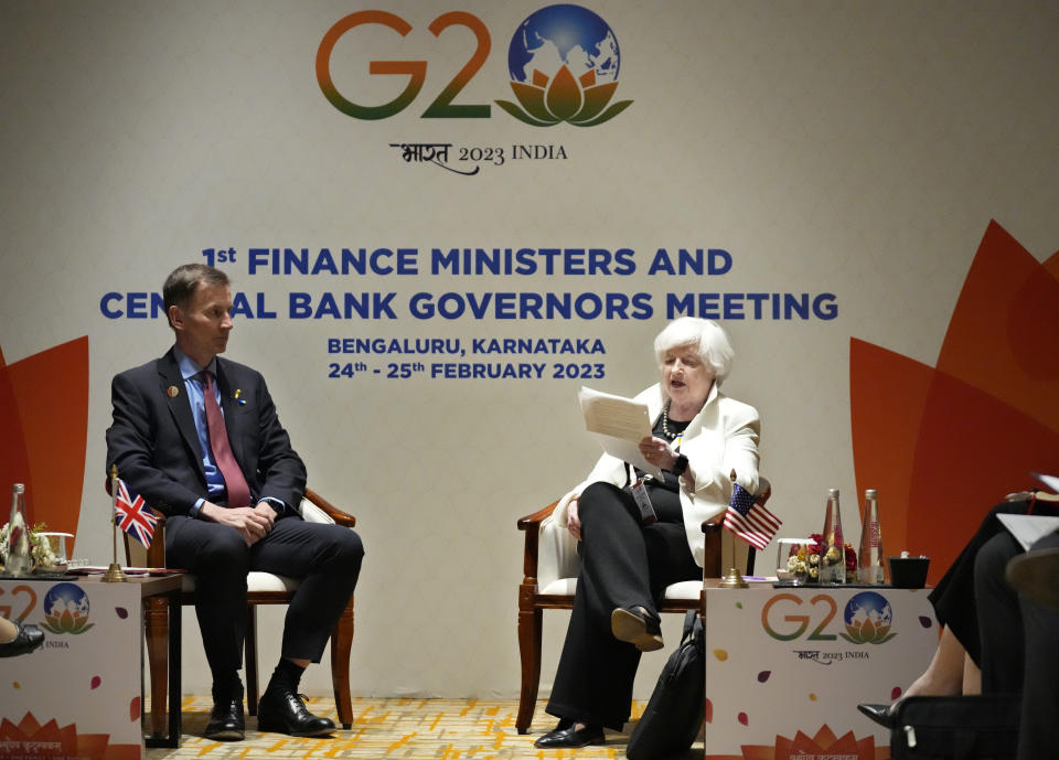 Britain's Chancellor of the Exchequer Jeremy Hunt, left, listens to U.S. Treasury Secretary Janet Yellen as she reads out a statement during their bilateral meeting on the sidelines of G-20 financial conclave on the outskirts of Bengaluru, India, Friday, Feb. 24, 2023. (AP Photo/Aijaz Rahi)