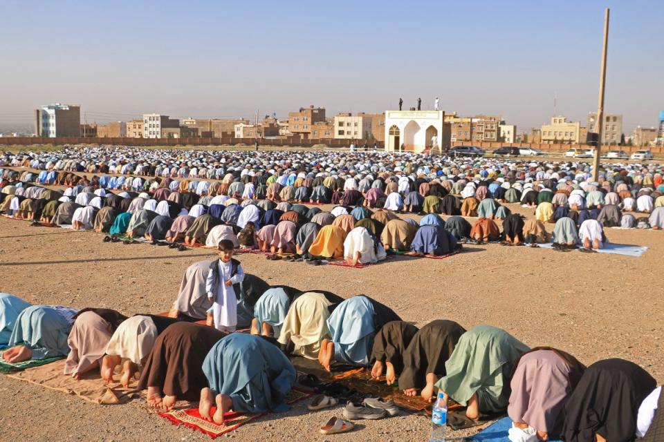 Muslim devotees offer Eid al-Fitr prayers, which marks the end of the holy fasting month of Ramadan at the Guzargah mosque on 10 April (AFP via Getty Images)