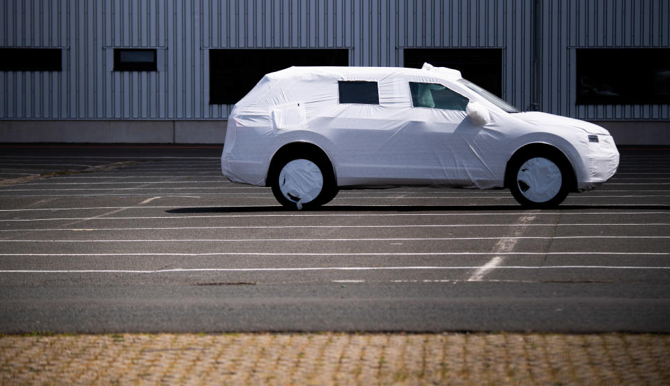 15 May 2020, Lower Saxony, Hanover: A packaged new VW vehicle is parked in a car park at the Volkswagen Commercial Vehicles plant. As expected, the Volkswagen Group has come under heavy pressure due to the corona sales restrictions. Worldwide the group brands delivered 473,500 vehicles in April, 45.4 percent less than in the same month last year. The corona crisis has plunged the entire German economy into recession. Photo: Julian Stratenschulte/dpa (Photo by Julian Stratenschulte/picture alliance via Getty Images)