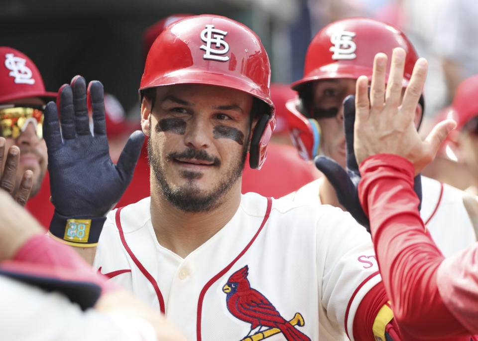 St. Louis Cardinals' Nolan Arenado celebrates with teammates in the dugout after hitting a two-run home run in the fifth inning of a baseball game against the Detroit Tigers, Saturday, May 6, 2023, in St. Louis. (AP Photo/Tom Gannam)