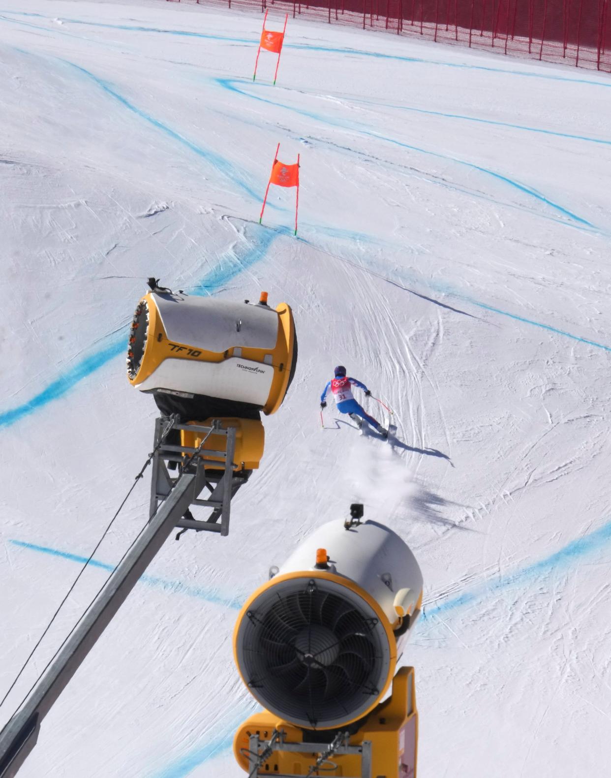 Alexis Pinturault, of France skis past snow making machines during a men's downhill training run at the 2022 Winter Olympics, Thursday, Feb. 3, 2022, in the Yanqing district of Beijing. (AP Photo/Luca Bruno)