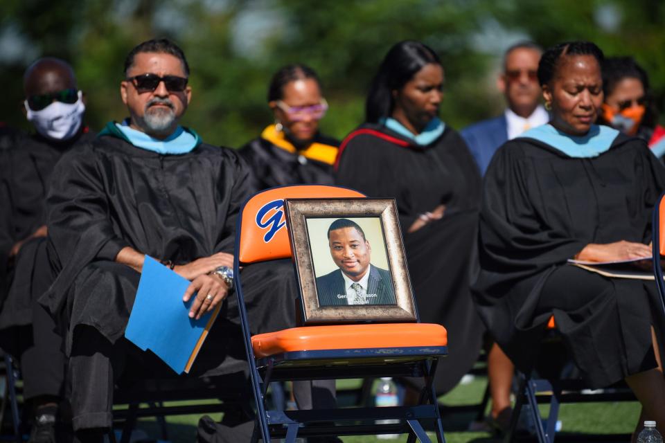 A framed photo of former Principal Principal Dr. Gerald Glisson, who died of Coronavirus complications last May, is seen on a chair as a 30 seconds of the silence is offered during the Eastside High School Class of 2021 Commencement at Bauerle Field in Paterson on 06/24/21.