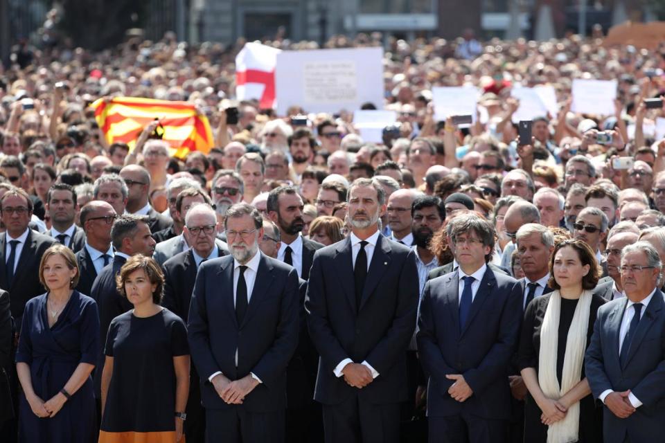 King Felipe of Spain and Prime Minister Mariano Rajoy observe a minute of silence in Barcelona (Reuters)