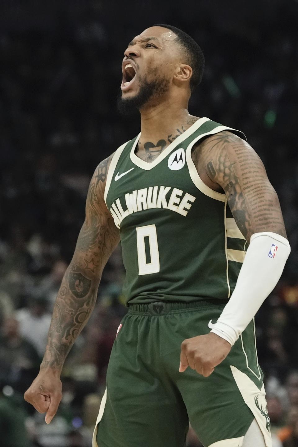 Milwaukee Bucks' Damian Lillard reacts after making a shot and being fouled during the first half of Game 1 of the NBA playoff basketball game Sunday, April 21, 2024, in Milwaukee. (AP Photo/Morry Gash)