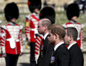 Britain's Prince William, left, and Prince Harry follow the coffin as it slowly makes its way in a ceremonial procession during the funeral of Britain's Prince Philip inside Windsor Castle in Windsor, England, Saturday, April 17, 2021. (Gareth Fuller/Pool via AP)