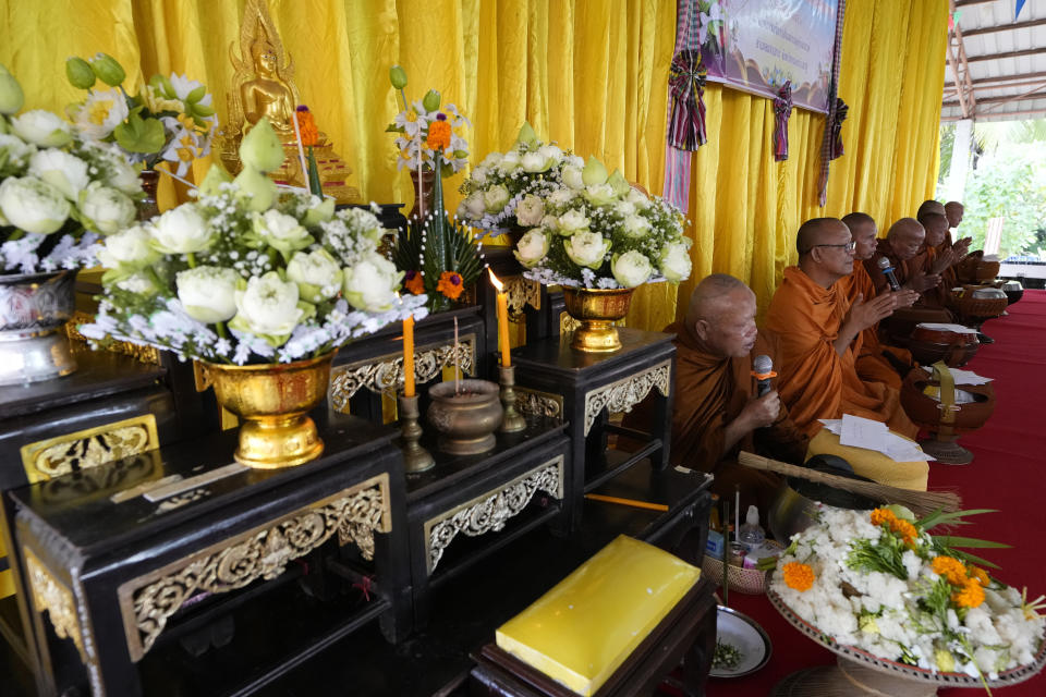 Buddhist monks pray in front of the relatives during the Buddhist ceremony in the rural town of Uthai Sawan, in Nong Bua Lamphu province, northeastern Thailand, Friday, Oct. 6, 2023. A memorial service takes place to remember those who were killed in a grisly gun and knife attack at a childcare center. A former police officer killed 36 children and teachers in the deadliest rampage in Thailand's history one year ago. (AP Photo/Sakchai Lalit)