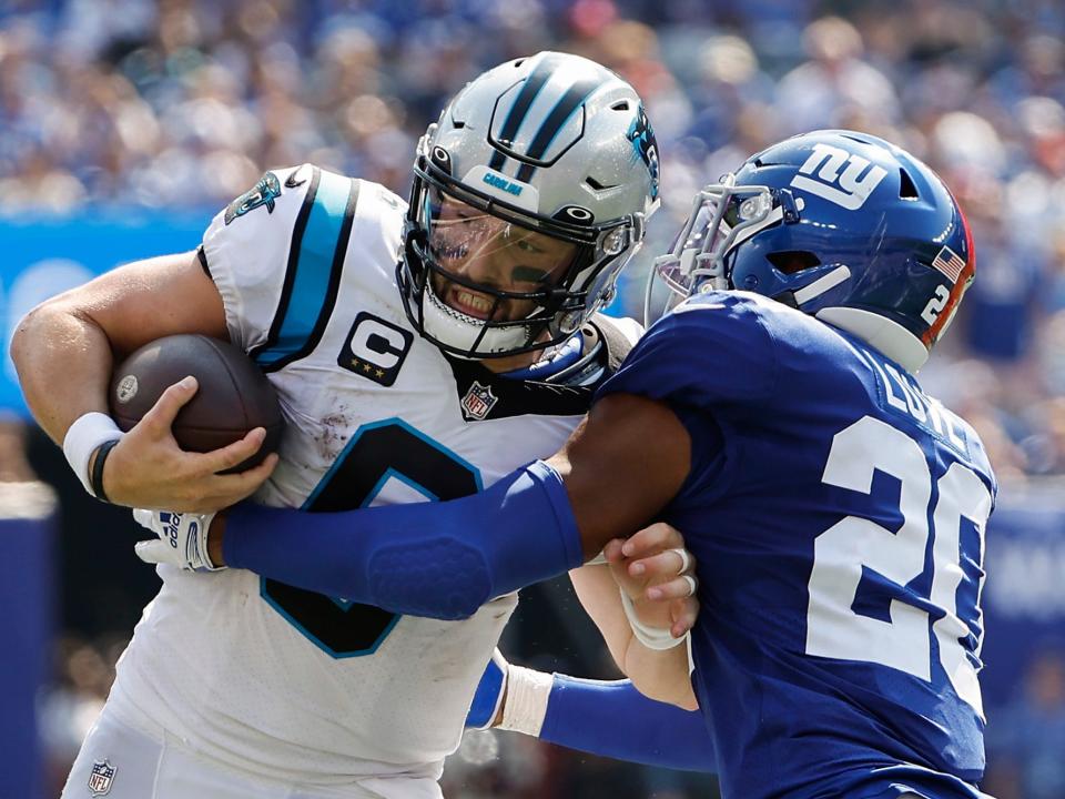 Baker Mayfield fights through a tackle against the New York Giants.