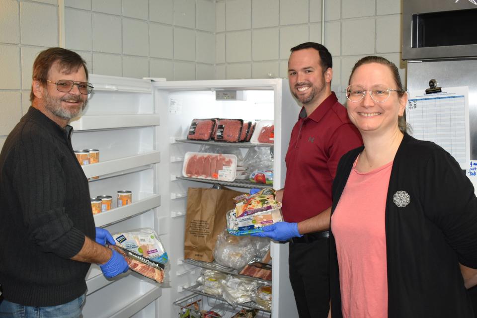 David Mullins, from left, First Presbyterian Church treasurer and pantry director; Andy Spellman, Oak Ridge branch campus director; and Mariella Akers, pantry manager and ORBC faculty secretary, load up the new freezer donated by the church.