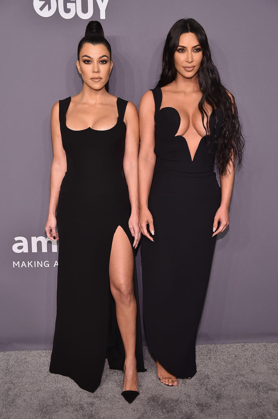 Kourtney (left) and Kim Kardashian wore remarkably similar Versace dresses to the gala [Photo: Getty]