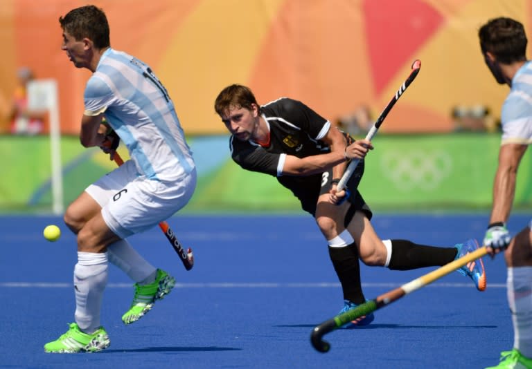 Argentina's Ignacio Ortiz (L) vies with Germany's Linus Butt during the men's quarterfinal field hockey Argentina vs Germany match of the Rio 2016 Olympics Games at the Olympic Hockey Centre in Rio de Janeiro on August 16, 2016